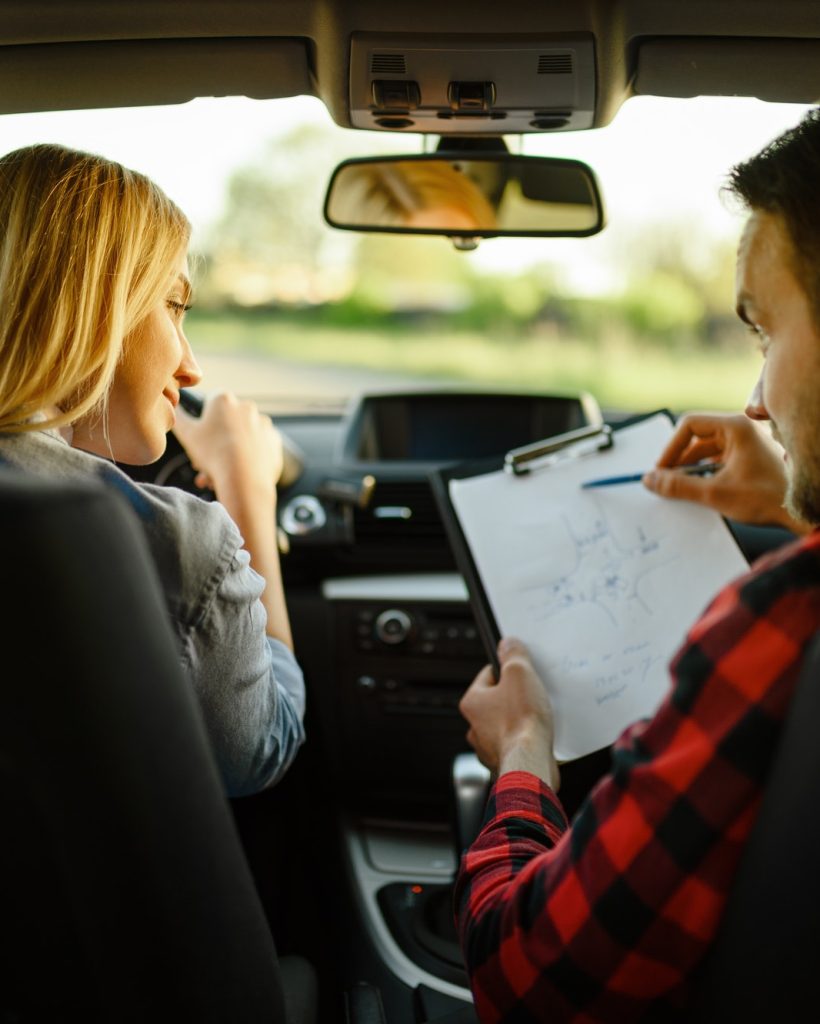 instructor-helps-woman-to-drive-the-car.jpg